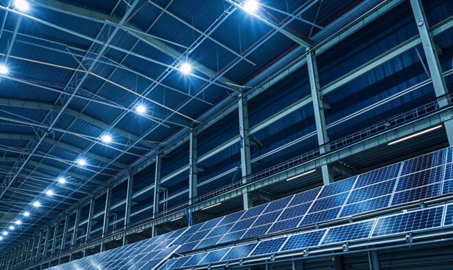 A warehouse equipped with green warehousing technologies, including solar panels and energy efficient lighting systems