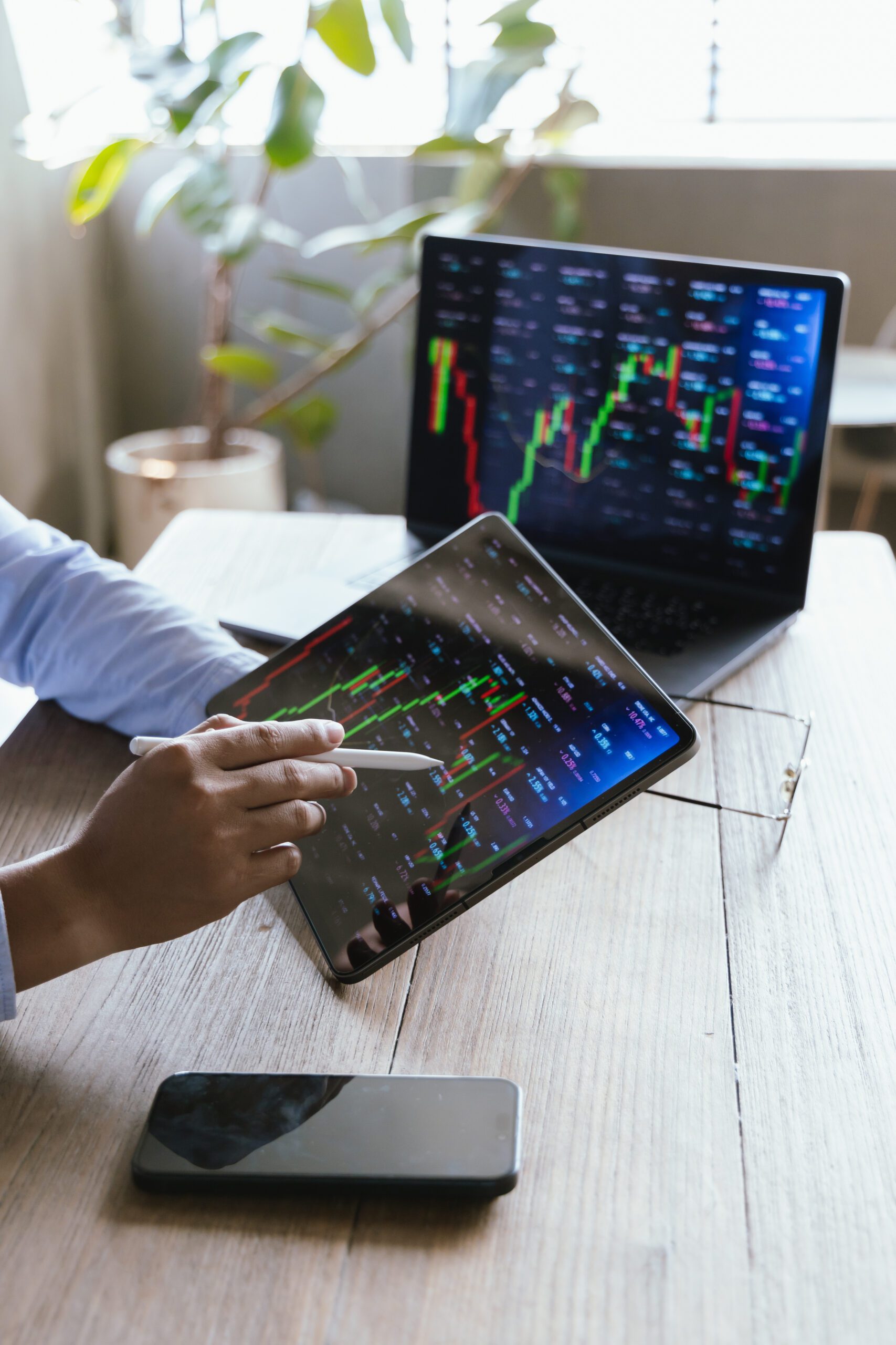 Businessman analyzing financial data by displaying charts and graphs showing global stock market and investment trends, strategies, trading and financial growth in modern office.